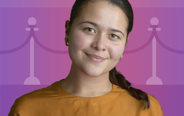 a student smiling in front of a purple and pink clipart backdrop