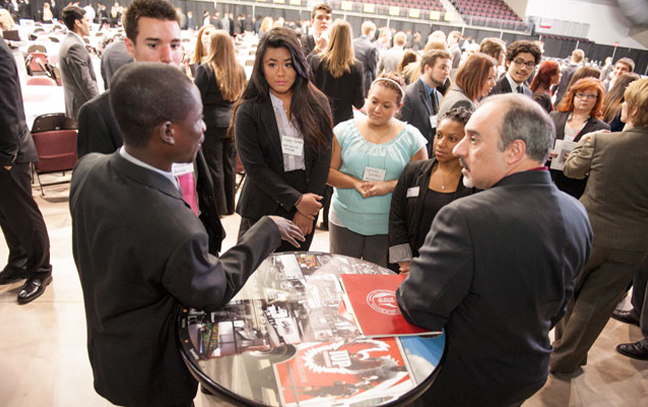 Entrepreneurship and Smalla group of students and professionals talk together at an eventBusiness Management, BS