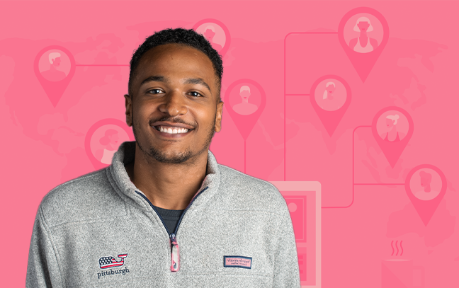 A smiling student wearing a gray Pittsburgh sweatshirt, in front of a pink design background.