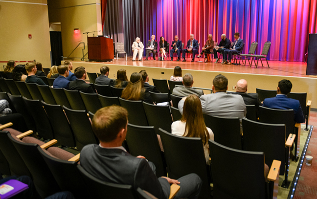 view of a speaker and an audience in an auditorium