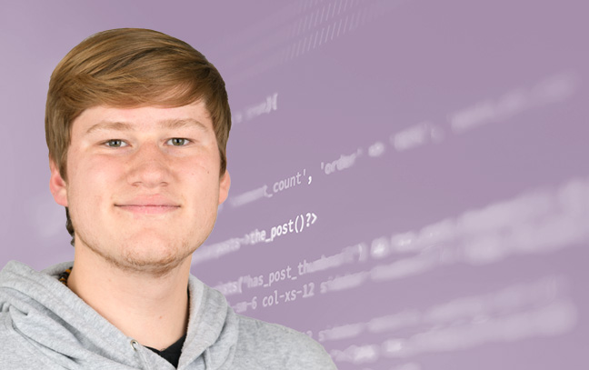 A student being superimposed in front of a purple background showing lines of code on a screen.