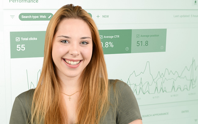 A student being superimposed in front of a green background showing graphs on a screen.