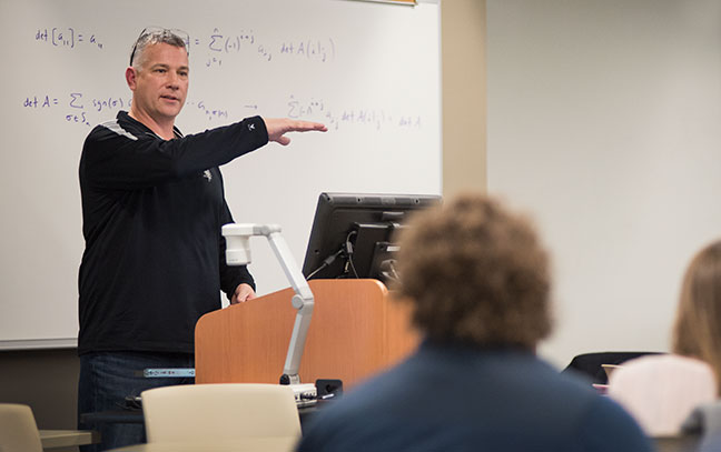 Students sitting as a teacher lectures