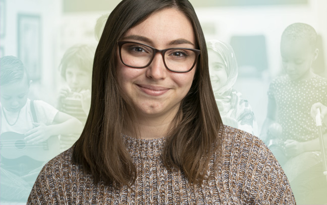 a student smiling in front of a blue and yellow clipart backdrop