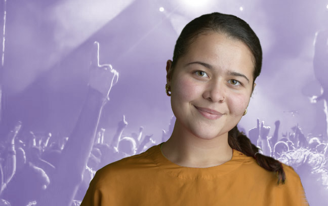 A student being superimposed in front of a violet background showing people at a concert.