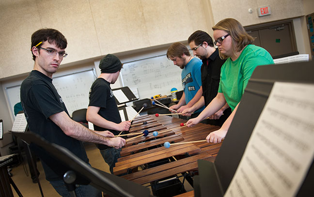 students playing music together in class
