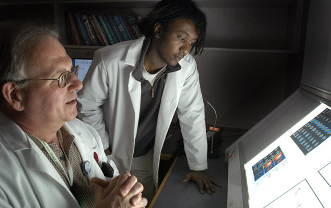 A student and professor looking at images on a screen