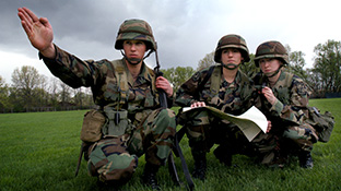 Three ROTC students during a field exercise