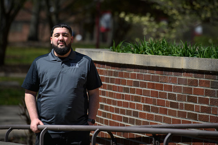 Gabe poses in front of McElheney Hall