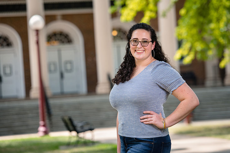 Mary Ellen smiles in the Oak Grove outside of Waller Hall.