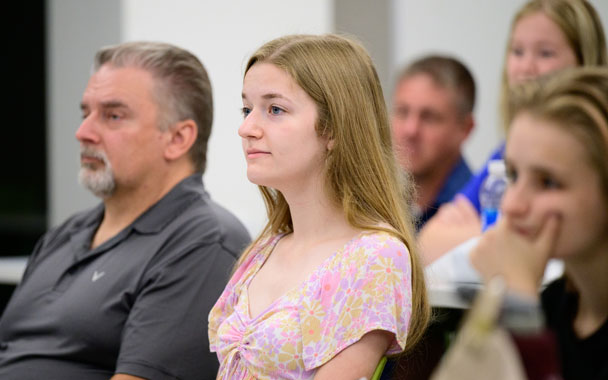 a female student looks ahead during a conversation about financial aid