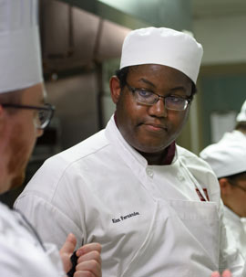 male culinary student listening to the check during an instruction