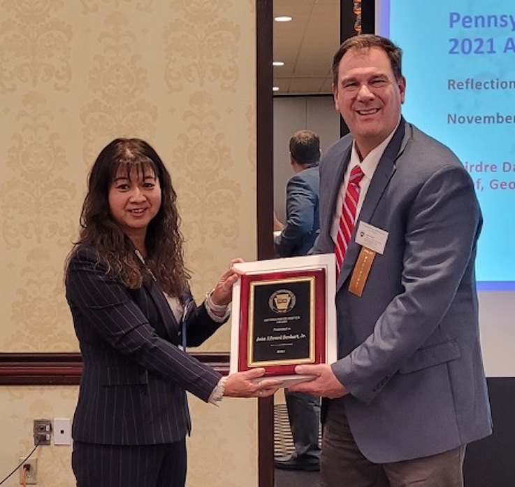 John Benhart Jr. receiving award from PGS