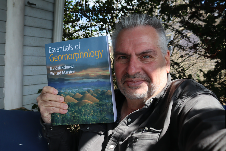 Dr. Kevin Patrick with the Essentials of Geomorphology text