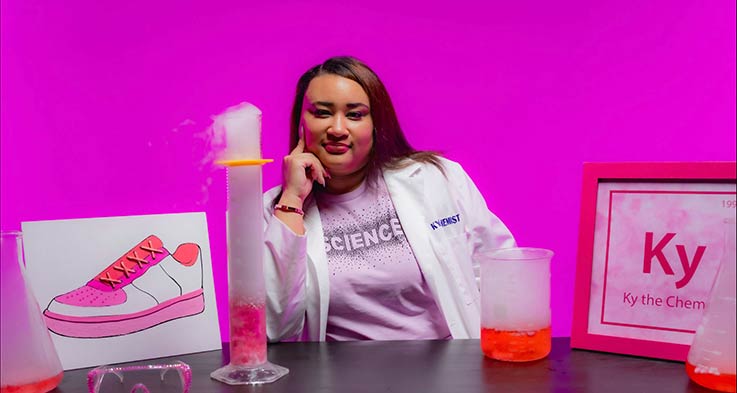 chemist seated at table with supplies