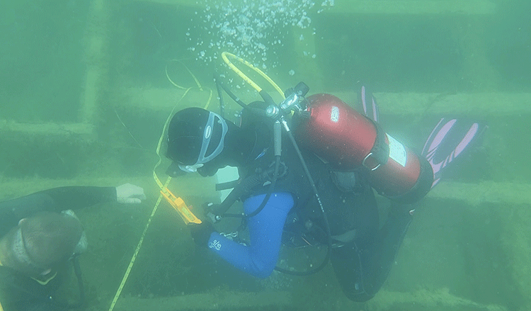 Archaeologists recording a site underwater.