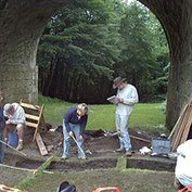Student work at a dig under an arch