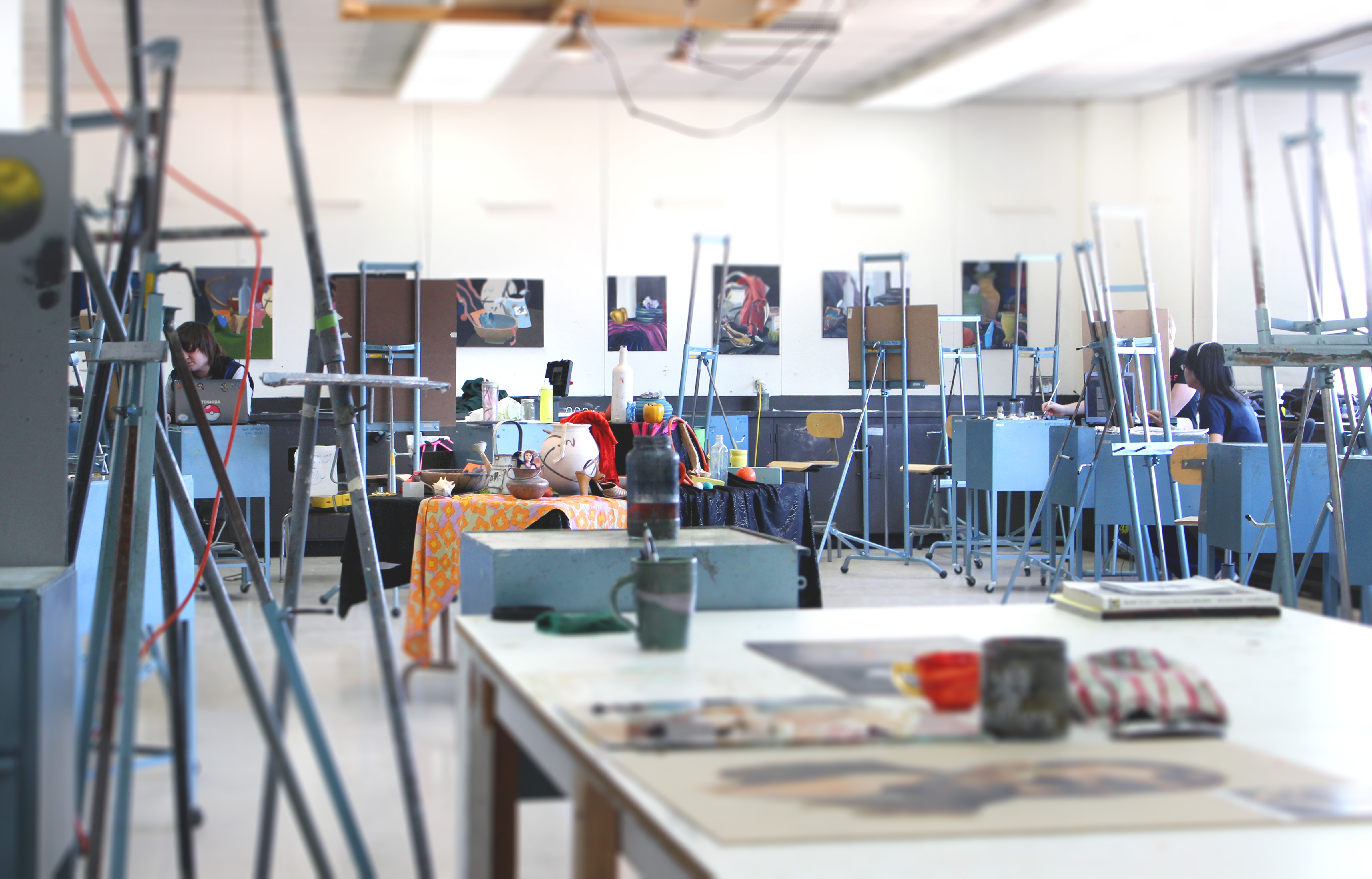 view of a paint studio with canvases and stations