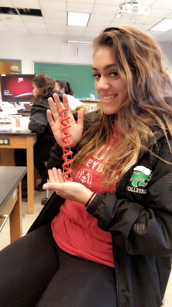 Student in a classroom demonstrating the Alpha Helix Protein