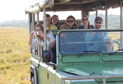 Students ride along in a land cruiser while on a safari in South Africa