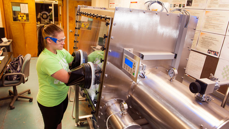Cassandra Hanley works with lab equipment