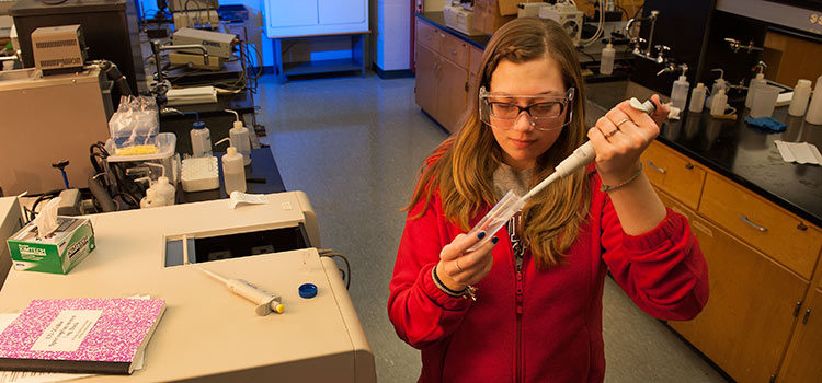 A student works on an experiment in a lab.