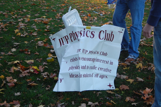 Physics Club flier being shown outside with students 