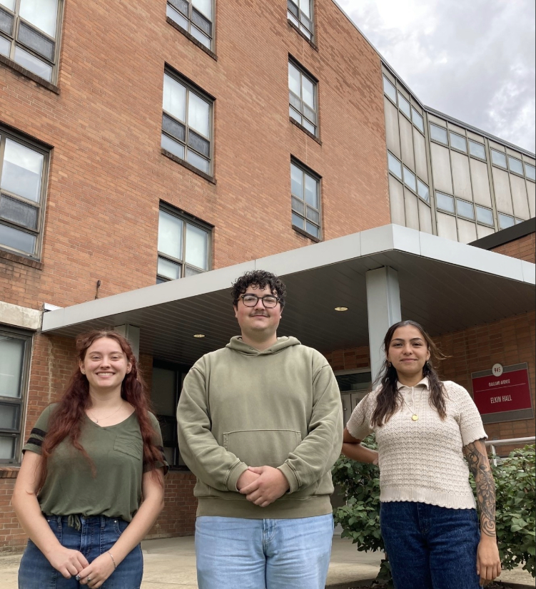 Brooke Eisenhuth, Kai Ratleff, and Sarah Logue in front of Elkin Hall