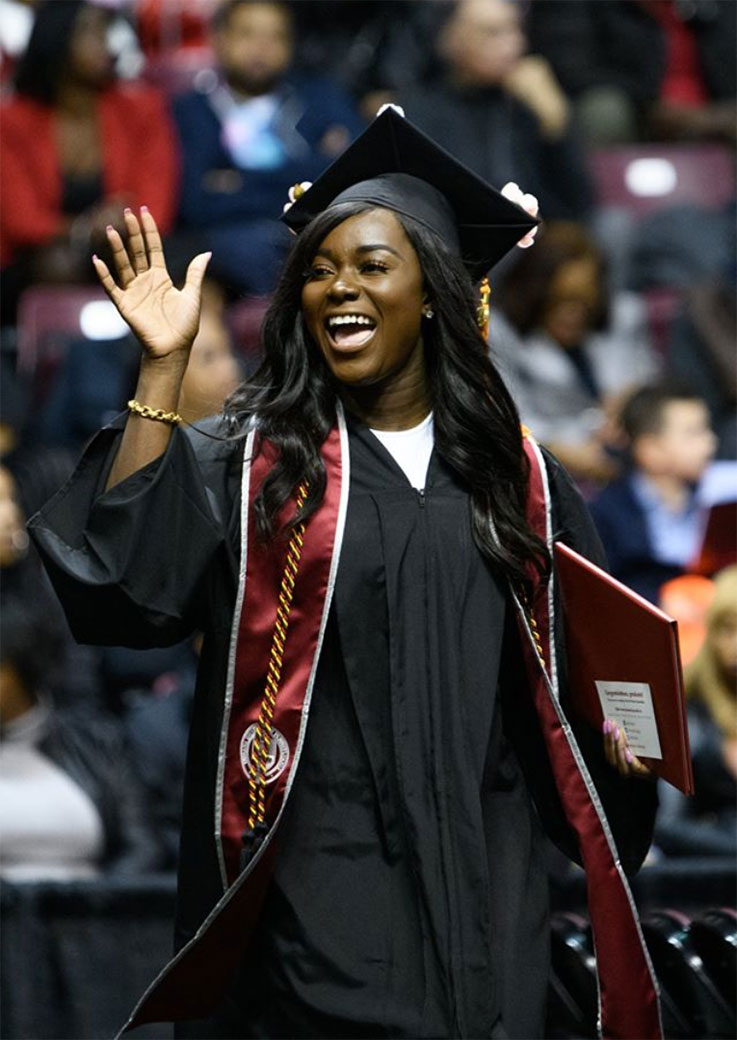 Commencement student waving 