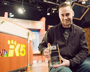 Matt Mrozinski holding an award