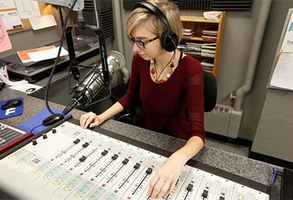 Student working in WIUP-FM studio