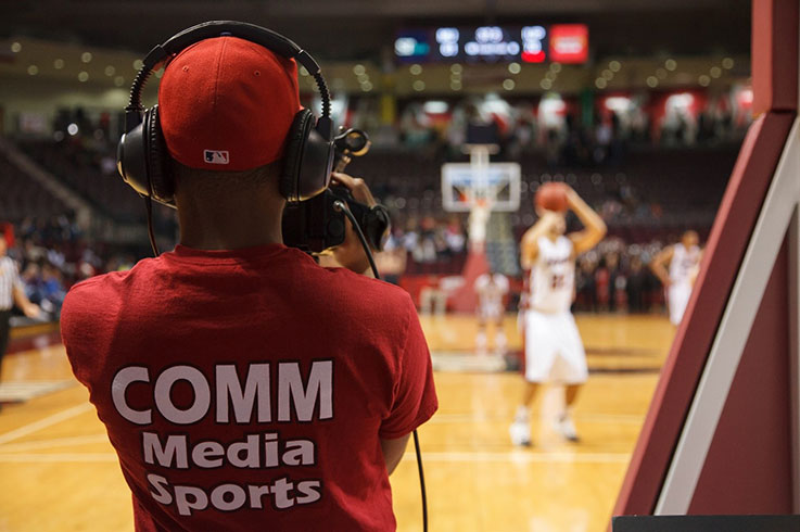 Student photographer at a basketball game