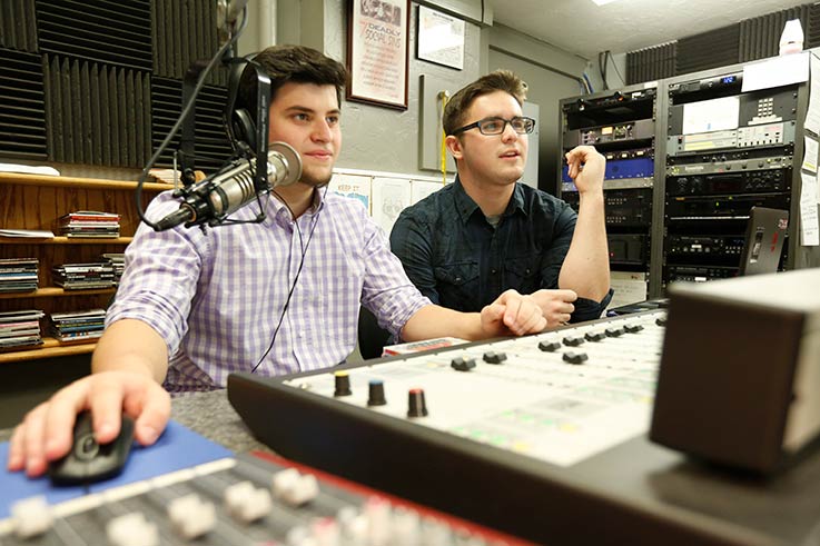 Students in the broadcasting booth at on WIUP FM