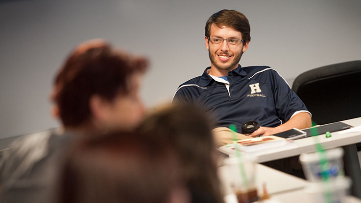 A student smiling in a classroom