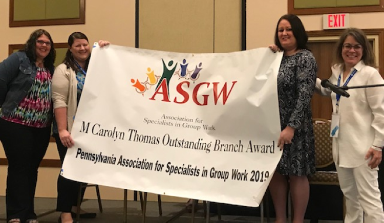 Ashley Coombs and Brittany Pollard accepting the M. Carolyn Thomas Outstanding Branch Award on behalf of the Pennsylvania Association for Specialists in Group Work