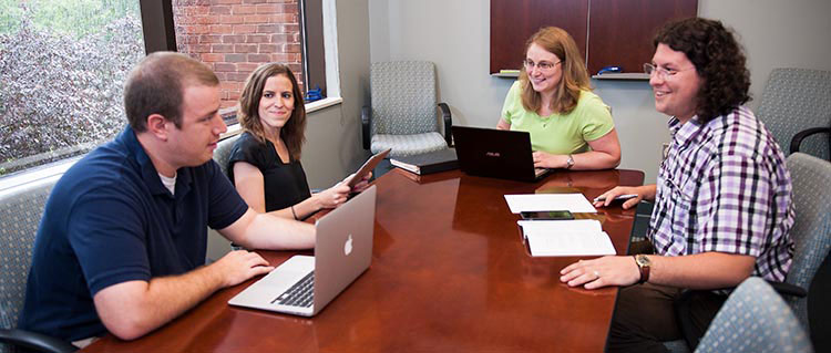 Criminology students meeting around a conferecne table