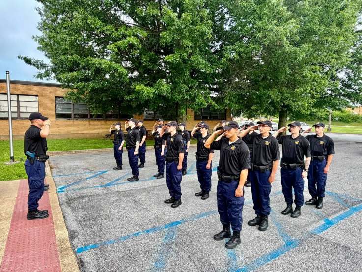 Police Academy cadets saluting their instructor