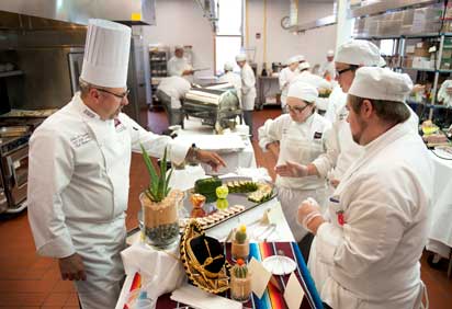 Culinary faculty instructing in kitchen