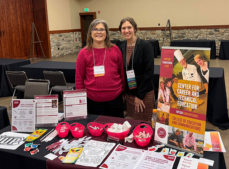 Student and faculty member at the IUP Center for Career and Technical Education table