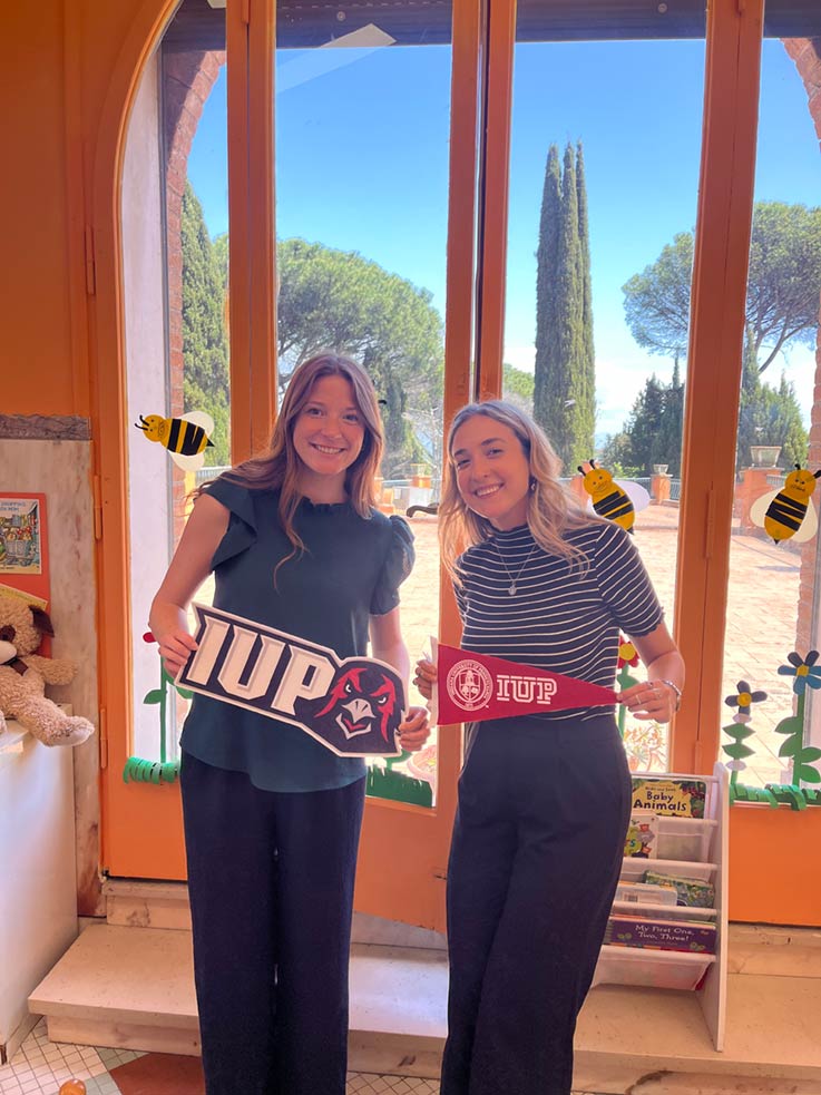 IUP Students holding IUP signs in Rome