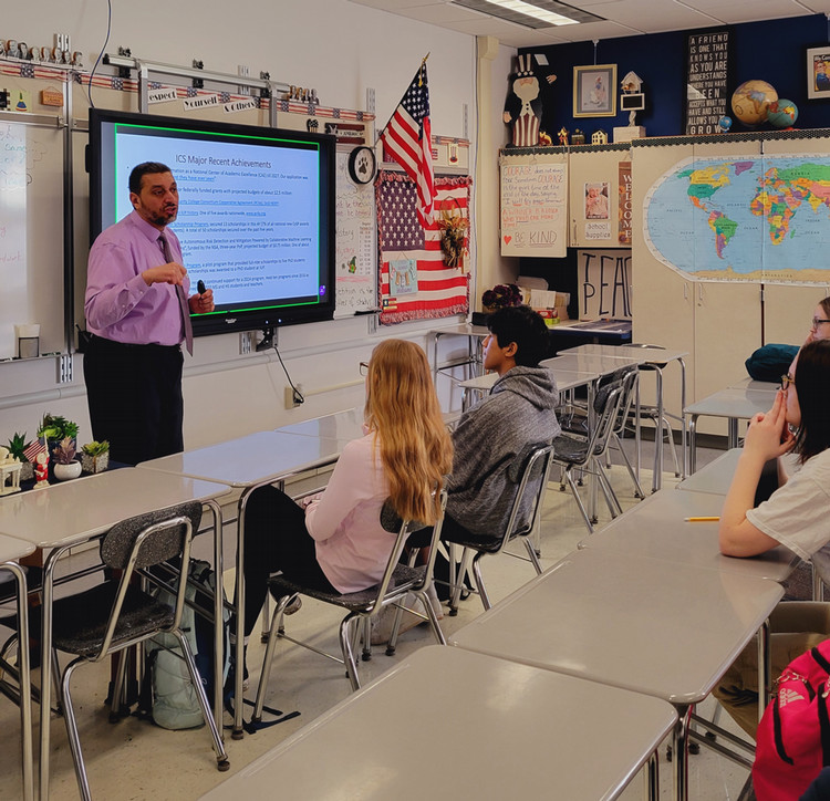 Farag presenting to student at Homer-Center High School