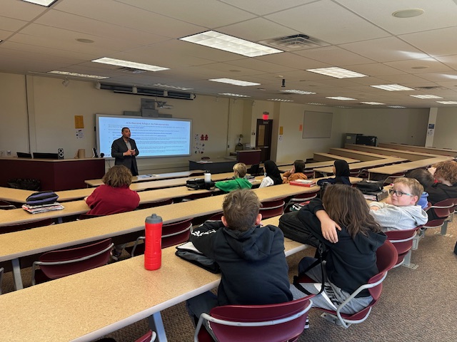 Waleed Farag presenting cybersecurity information to middle school students