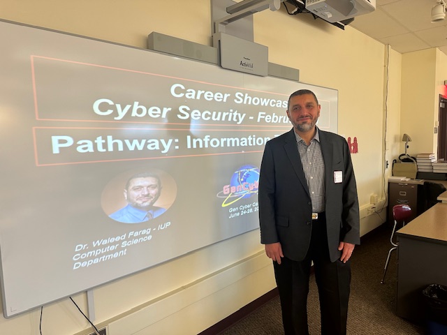 Waleed Farag presenting cybersecurity information to middle school students