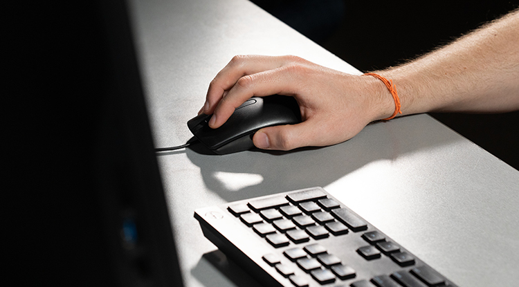 close up of a hand holding a computer mouse