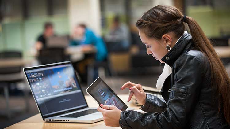 Student using a computer and iPad