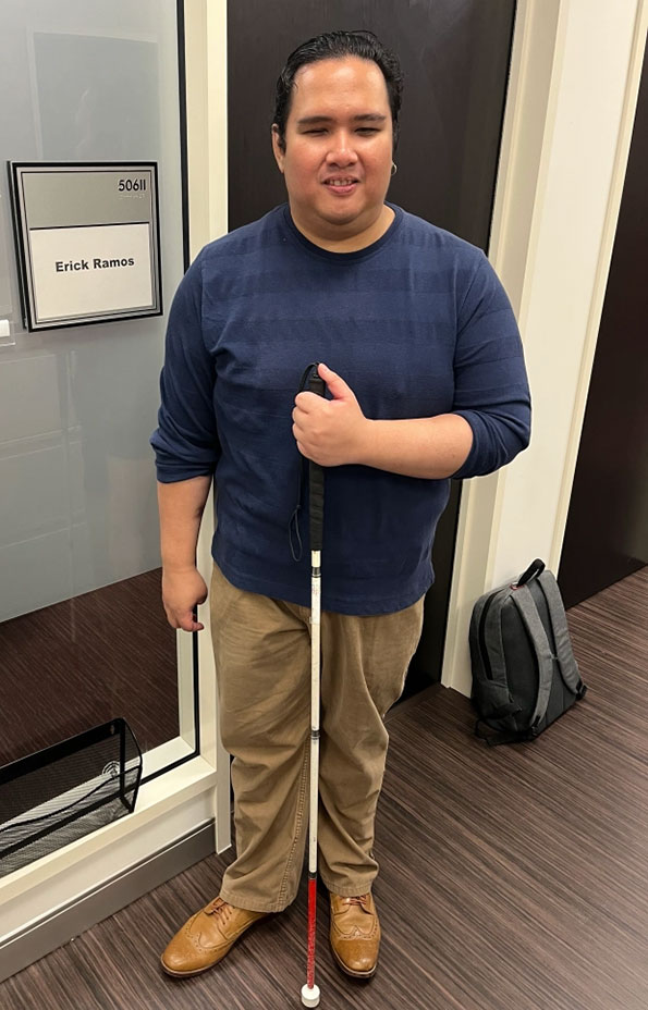 Erick Marco Ramos standing in front of office.