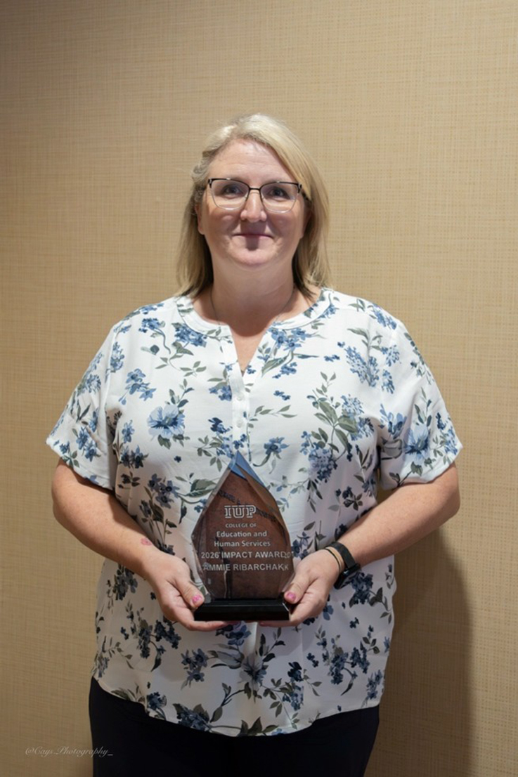 Ammie Ribarchak holding Impact Award