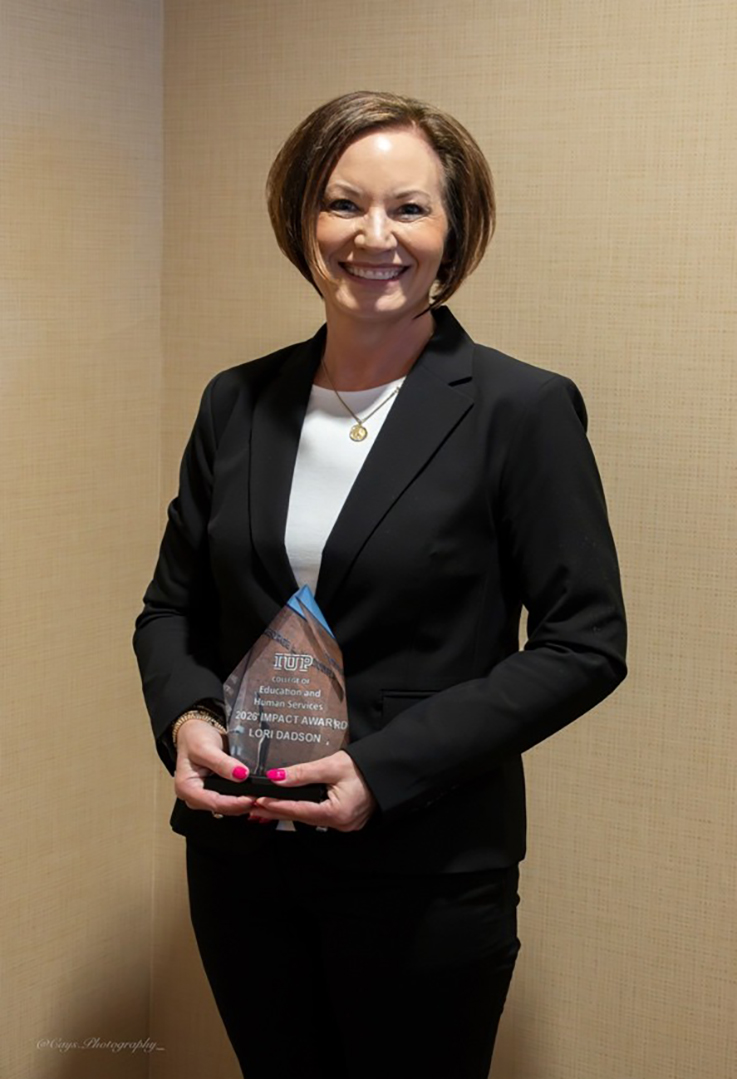 Lori Dadson holding Impact Award