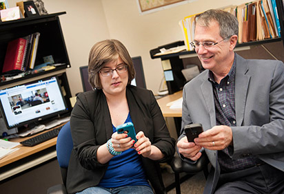 Emily Weber and Dr.Ben Rafoth look at the writing center app