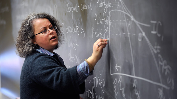 Professor Stephanie Jozefowicz writes on chalkboard